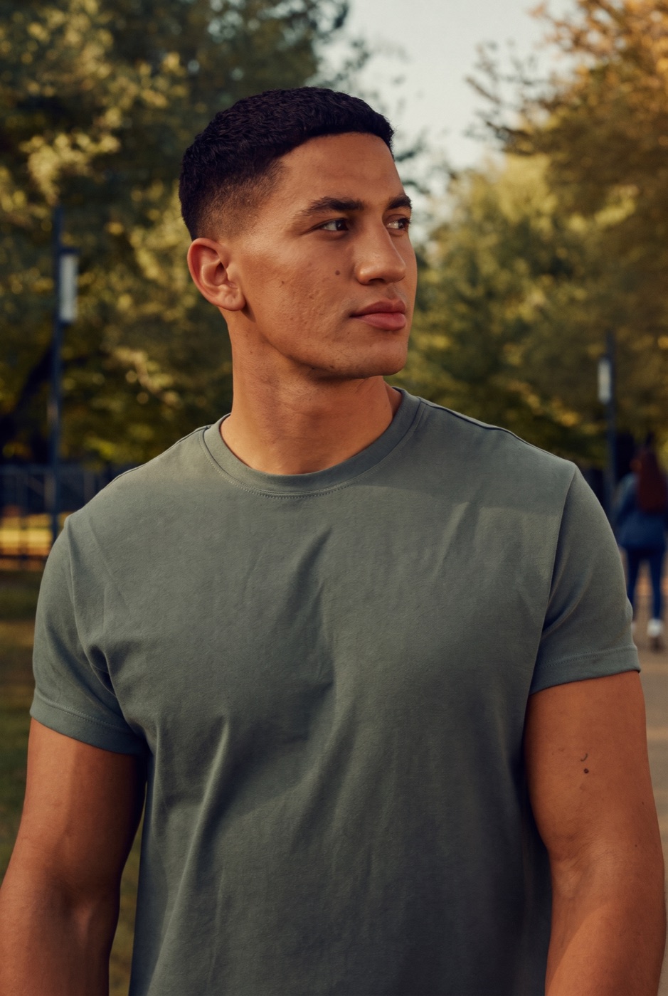 A man walking through a park in morning light